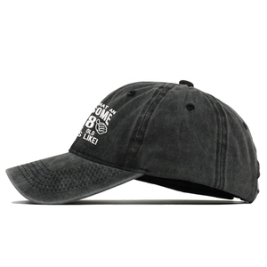 Detail of charcoal grey 80th birthday baseball cap with awesome embroidered slogan