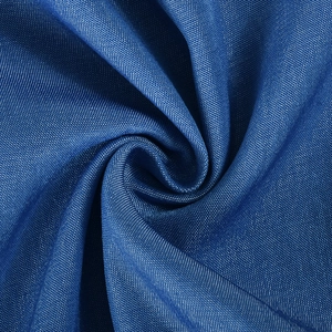 Detailed close-up of dark blue fabric texture showing elegant draping and fiber weave