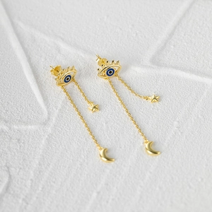 Detailed view of s925 silver evil eye gold earrings with star and moon tassel chains