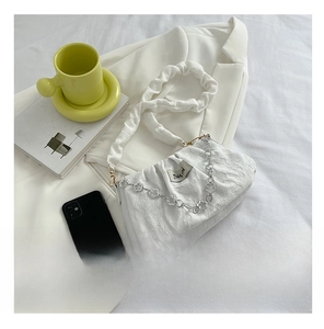 White lace pleated underarm bag with gold chain strap and leather logo detail
