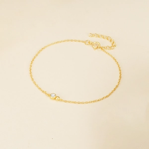 Detail view of gold lobster clasp and adjustable extension chain on zircon bracelet