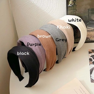 Detailed flat lay of wide houndstooth headbands in six stylish assorted colors