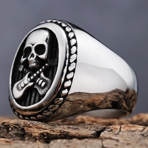 Punk retro stainless steel skull and guitar embossed ring on rustic wood background