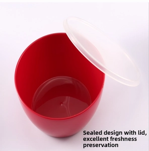 Detail view of red circular food bowl with a translucent airtight sealing lid