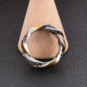 Detailed view of hip hop hollow Cuban link ring with rhinestones on a wooden cone stand