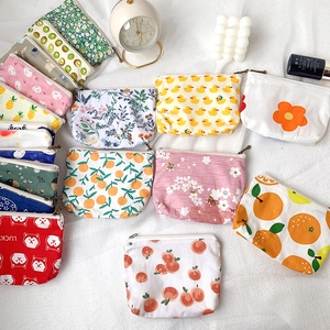 Detail of mini canvas coin purses with cute prints and smooth zipper closure