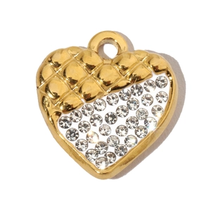 Macro detail of a gold heart-shaped pendant with diamond-encrusted pattern on white background