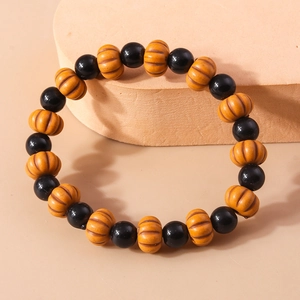 Detail shot of Halloween beaded bracelet featuring orange pumpkin and black round beads