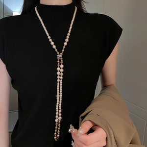 Elegant multi-layered long pearl necklace with crystals and champagne gold accents