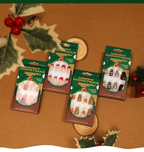 Detailed view of Christmas themed ballet press-on nails in festive gift packaging