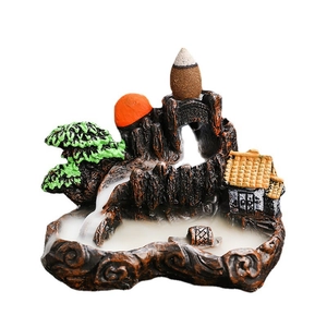 Zen backflow incense burner featuring resin mountain landscape and small boat on white background