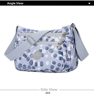 Close-up of lilac nylon shoulder bag featuring white polka dots and multi-zipper layers
