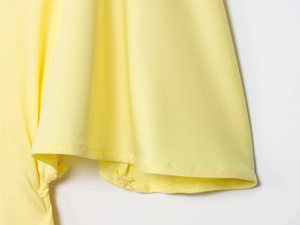 Detailed close-up of yellow layered ruffle sleeve with precision double-stitching