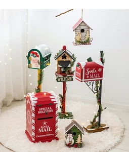 Detailed view of red wooden Christmas mailboxes and birdhouses with festive warm lights