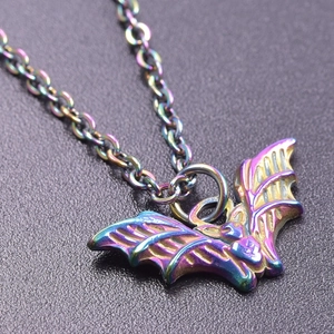 Macro shot of colorful rainbow stainless steel bat pendant on a metallic chain necklace