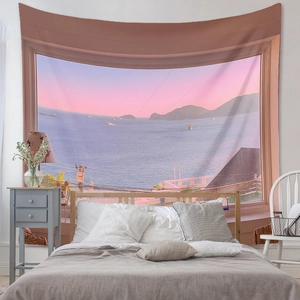 Detail showing sunset ocean view tapestry hanging above bed in a modern bedroom