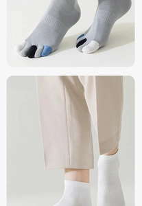 Detail von grauen Zehensocken mit bunten Zehen und weißen mittellangen Baumwollsocken