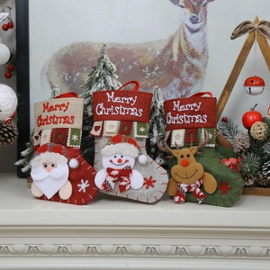 Three Christmas stockings with Santa, snowman and reindeer figures on a fireplace mantel