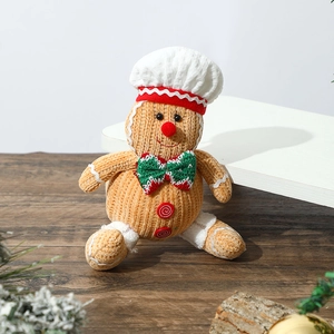 Close-up of a gingerbread man plush toy featuring a chef hat and red bowtie for Christmas
