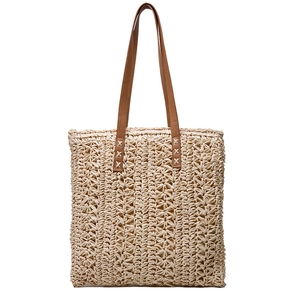 Detailed view of the woven straw tote bag texture with brown faux leather shoulder strap