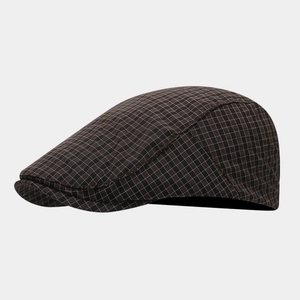 Detail of classic dark brown plaid flat cap showing fine texture and stitching