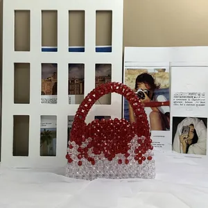 Detail of red and clear faceted beads on a handmade woven crossbody handbag