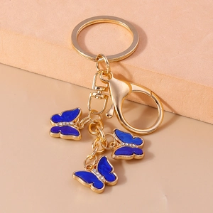 Detailed close-up of blue butterfly key ring with sparkling rhinestones and gold lobster clasp