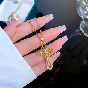 Macro view of gold cross pendant with micro-inlaid zircon and vintage lace pattern