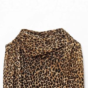 Leopard print halter neck dress with elegant draped neckline detail and animal pattern