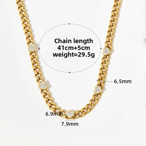 Detail of gold Cuban chain necklace with five pave-set zircon heart pendants on white background