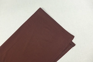 Detailed close-up of double-stitched seams and dark brown fabric texture of the bodysuit