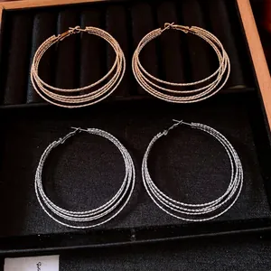 Fashion multi-layer round hoop earrings in gold and silver finishes with fine metal texture