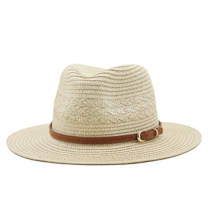 Minimalist beige straw Panama hat with brown leather band and gold buckle for summer vacations