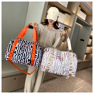 Close-up of stylish travel duffel bags featuring vibrant Music and Vibes letter prints