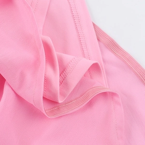 Close-up of pink lightweight fabric showing detailed stitching and elastic edging details