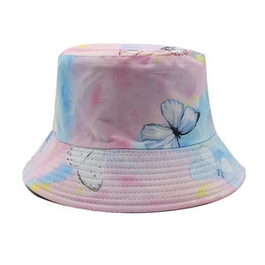 Détail du tissu tie-dye coloré avec imprimés de papillons bleus sur un chapeau bob