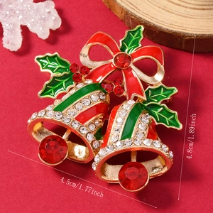 Christmas double bell brooch with red bow and green holly leaves on red felt background