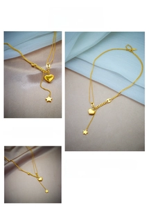 Detail of 18K gold-plated Y-shaped necklace with star and 3D heart-shaped pendants