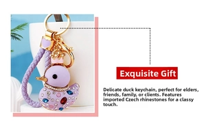 Detail of purple rhinestone duck keychain with gold crown and woven leather strap