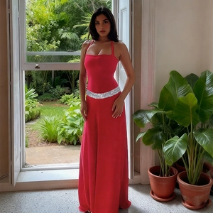 Detail of red halter dress featuring sparkling silver sequins on the waistline belt