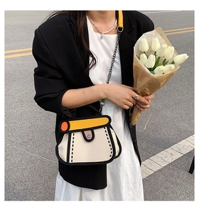 Close-up of the creative 2D cartoon canvas handbag held by a model with tulips
