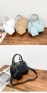 Detailed macro view of quilted shell handbag set with petal zippers and mini coin purse