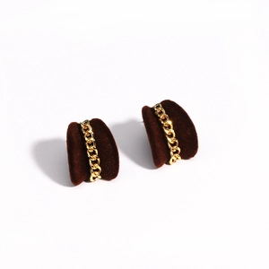 Detail of brown flocked earrings featuring integrated gold chain link accents