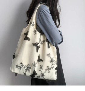 Detail of floral butterfly embroidery on double-layer mesh and canvas tote bag