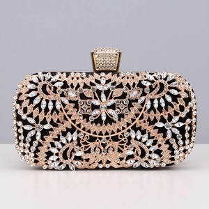 Close-up of evening clutch bag with rose gold floral filigree and sparkling crystals