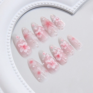 Pink and white gradient press-on nails with 3D floral art and pearls on mirror