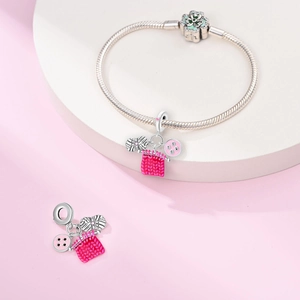 Detailed macro view of 925 silver knitting charms with pink enamel and snake chain