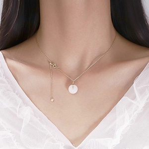 Detailed view of Hetian jade Pingan buckle pendant necklace on gold chain with heart tag