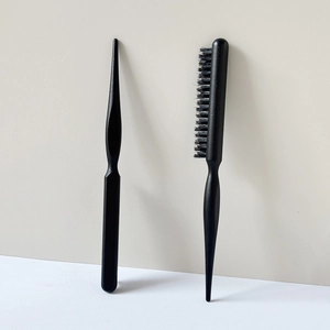 Macro view of professional three-row teasing hairbrush with pointed tail handle