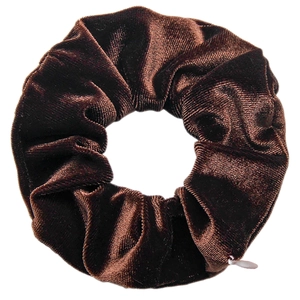 Detail of brown velvet scrunchie with soft texture and glossy finish on white background